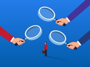 An illustration of a businessman under several magnifying glasses