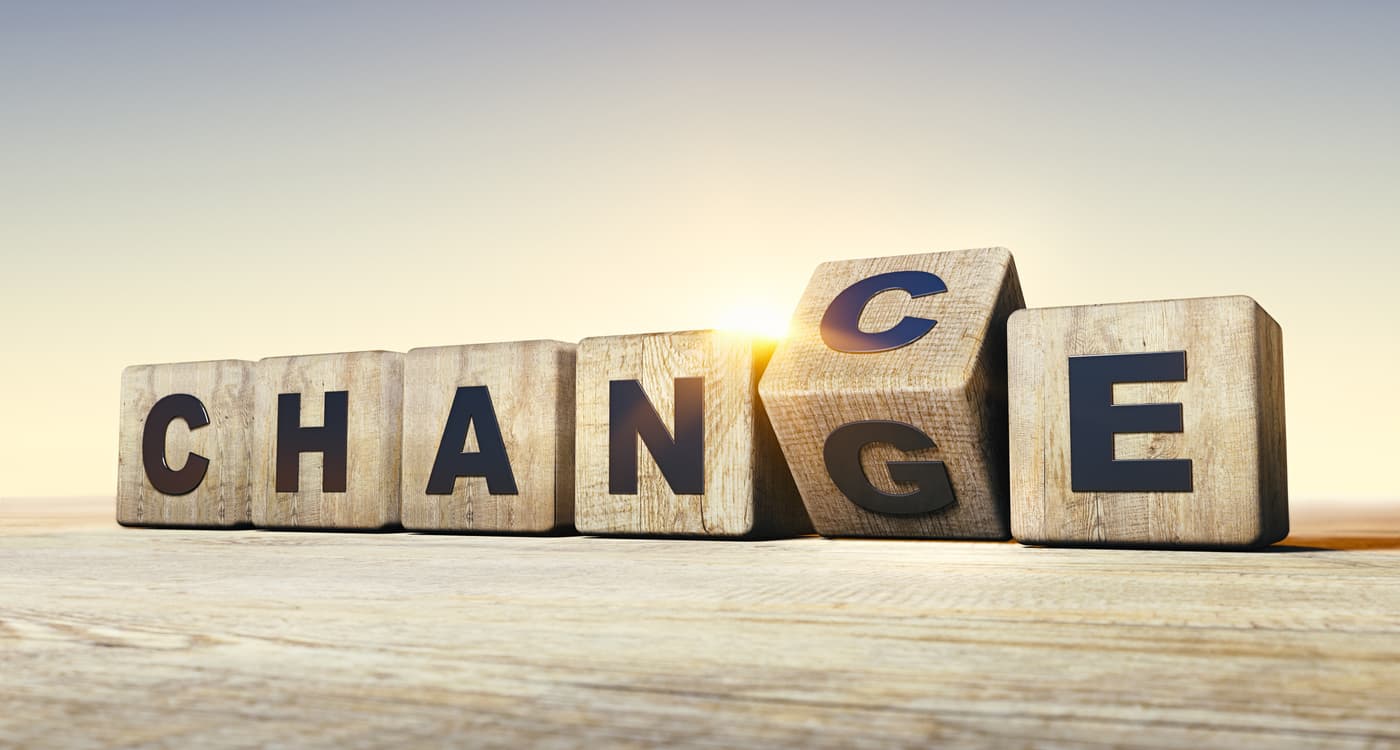 Lettered wooden blocks shifting to form the word “Chance” from “Change”