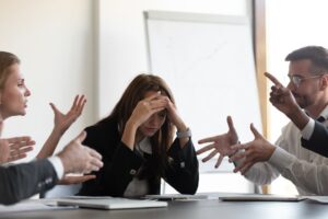 A group of professionals arguing in a conference room
