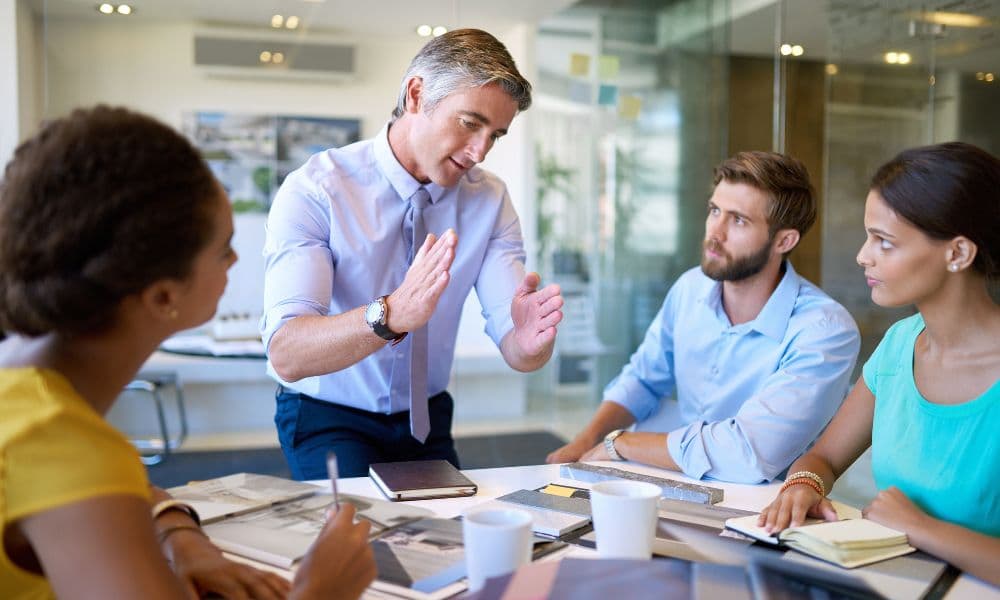 A team leader facilitating a Q1 strategy session with attentive employees.